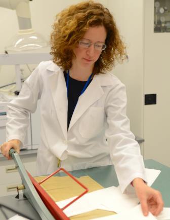 Dr. Catherine Stephens cutting cotton paper samples to be exposed to cycling humidity environments