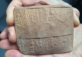 The obverse side of an Old Assyrian envelope fragment decorated with impressions created by a cylinder seal.