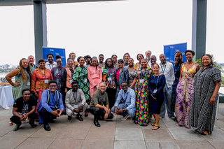 A group of symposium attendees smiling at the camera.